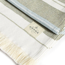 Load image into Gallery viewer, Up close view of black and blue blanket with Amana label