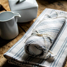 Load image into Gallery viewer, light blue Vintage Ticking Tea Towel &amp; Dish Cloth Set on a table with cups
