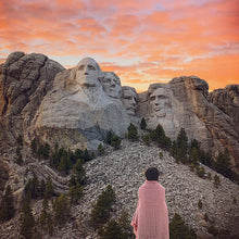 Load image into Gallery viewer, Red Hardy Houndstooth Cotton Throw Blanket wrapped around person at foot of Mount Rushmore
