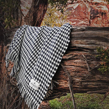 Load image into Gallery viewer, Navy Hardy Houndstooth Cotton Throw Blanket draped on tree branch
