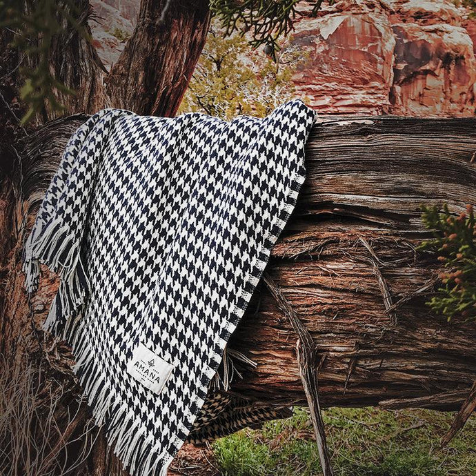 Navy Hardy Houndstooth Cotton Throw Blanket draped on tree branch