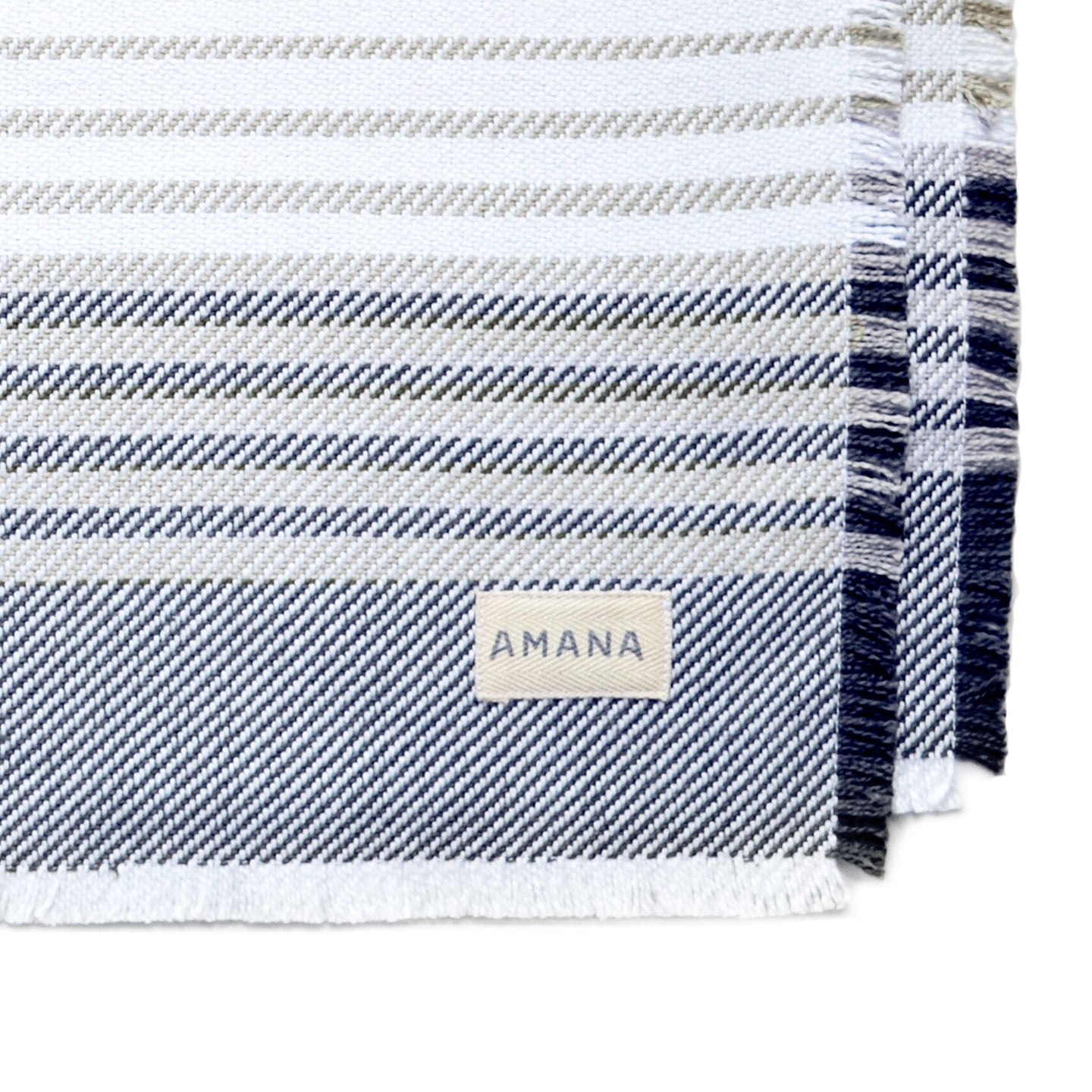 corner of navy/dark linen contempo placemat with Amana label